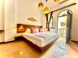 a bedroom with a large bed in a room at Masaya Cartagena in Cartagena de Indias