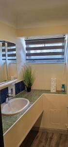 a bathroom with a sink and a window at Summer in Riga