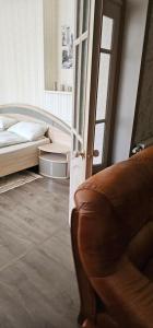 a bedroom with a bed and a chair next to a door at Summer in Riga