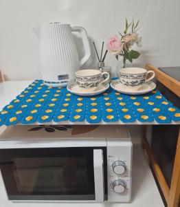 a table with two cups on top of a microwave at Daon 101 in Seoul +4 photos