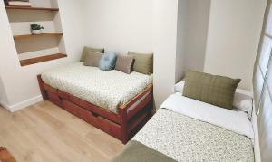 a room with two beds in a room at Apartamento Sotavento - 2 dormitorios in Chipiona