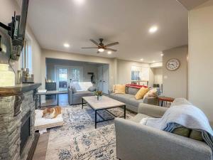 a living room with two couches and a fireplace at Spa Lodge Sleeps 9 Sauna Hot Tub Mtn Views in Fletcher