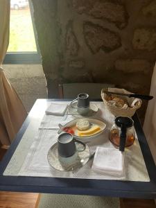 a table with a plate of food on it at Casa MARGO in Lajes +4 photos
