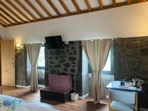 a bedroom with a bed and a chair and a table at Casa MARGO in Lajes