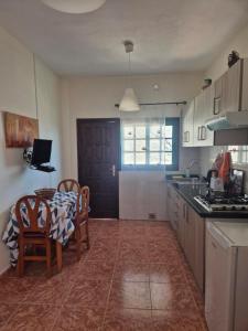 a kitchen with a table and chairs and a dining room at Casa Cira in Calera