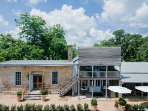 an exterior view of a brick building with a porch at Hotel Lulu in Round Top