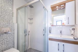 a bathroom with a shower and a sink at Sardunya Andifli Otel in Kas