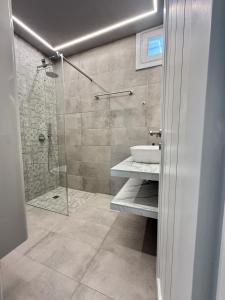 a bathroom with a shower and a sink and a toilet at Playera Bungalow G sea view in Naousa
