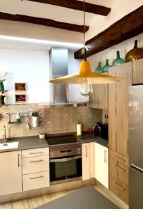 a kitchen with white cabinets and aendant light at Ca La Abuela in Requena