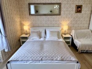 a bedroom with a large white bed with two night stands at Romance in the Old Town in Prague