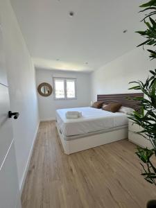 a white bedroom with a bed and a mirror at Calahonda Delux in Sitio de Calahonda +26 photos
