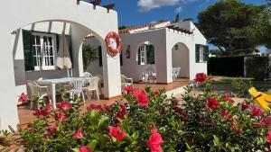 a house with flowers in front of it at Binibasket in Ciutadella