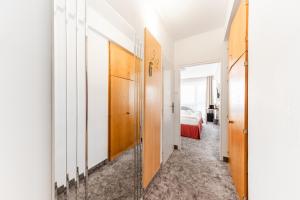 a hallway with a door leading to a bedroom at Hotel Oáza Praha in Prague +12 photos