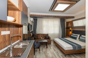 a hotel room with a bed and a sink at La Serena Taksim in Istanbul