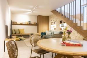 a living room with a table and chairs at Bacchetta Magica by PaxosRetreats in Gaios