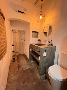 a bathroom with a sink and a toilet at Villa Nooma Alentejo in Vila Fernando +24 photos