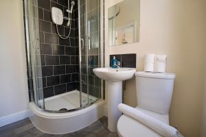 a bathroom with a shower and a toilet and a sink at Belgrade Lodge Studio 1 - City Centre, WiFi, Parking in Coventry