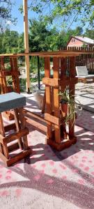 a wooden bench and a potted plant on a patio at Inboks 