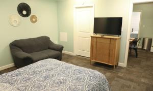 a bedroom with a bed and a tv and a chair at 2 Bedroom Unit in Daniels