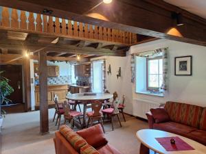 a living room with a table and chairs and a kitchen at Hotel Heißenhof in Inzell