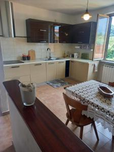 a kitchen with a wooden table and a dining room at Anna's Little House, Cinque Terre, Lerici in Arcola