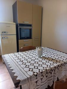 a kitchen with a table with a table cloth on it at Anna's Little House, Cinque Terre, Lerici in Arcola