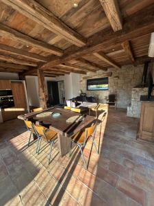 a dining room with a wooden table and chairs at Casa Scaledda in Bocognano
