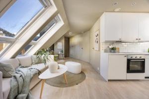 a living room with a couch and a table at Top-Floor Gem with City Views in Bergen