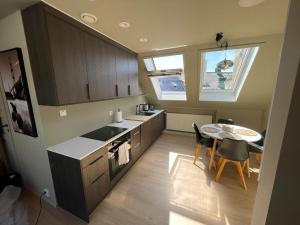 a kitchen with a table and a kitchen with a window at Top-Floor Gem with City Views in Bergen +20 photos