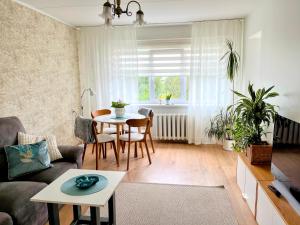 a living room with a table and a couch at Vabaduse apartment in Võru
