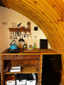 a kitchen with a wooden counter with a stove at Henny Riverside Glamping in Sudbury