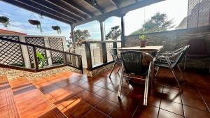 a patio with a table and chairs on a deck at Relaxing Villa Las Torres in Adeje