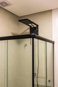 a shower in a bathroom with a glass shower stall at Flats Four Seasons by RD Stays in Bombinhas +10 photos