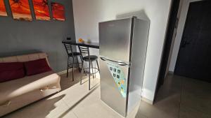 a stainless steel refrigerator in a kitchen with a counter at Hermoso Monoambiente con Vista Increible in Santa Cruz de la Sierra