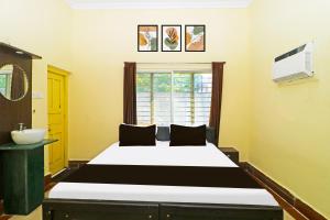 1 dormitorio con 1 cama blanca grande y lavamanos en HOTEL O OXY RUDRA INN, en Ranchi