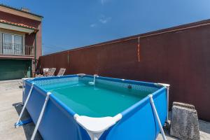 a blue pool table with a chair in front of a wall at GuestReady - Lovely escape in the countryside in Aveiro