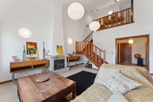 a living room with a couch and a table at GuestReady - Lovely escape in the countryside in Aveiro +59 photos