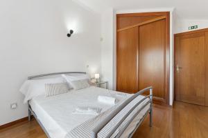 a bedroom with a bed and a wooden door at GuestReady - Lovely escape in the countryside in Aveiro