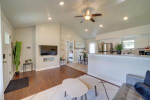 a living room and kitchen with a ceiling fan at 1 Mi to Tulsa Arts District Home with Yard! in Tulsa