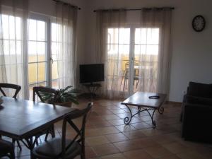 a living room with a table and chairs and a television at Appartements Vanii in Rust