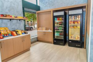 a store with two refrigerators with food and drinks at Holiday Inn Express Hotel & Suites Pittsburgh-South Side by IHG in Pittsburgh