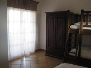 a bedroom with a bunk bed and a window at Appartements Vanii in Rust