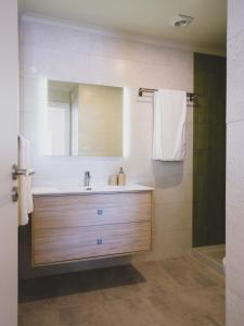 a bathroom with a sink and a mirror at Casa p'ra Muralha in Óbidos +19 photos