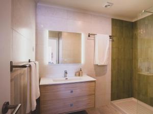 a bathroom with a sink and a shower at Casa p'ra Muralha in Óbidos +73 photos