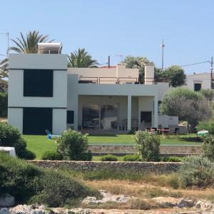 a house in the middle of a field at Agua en las Rocas in Sa Caleta +7 photos