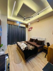 a bedroom with a bed and a black curtain at Visitor stop in Greater Noida