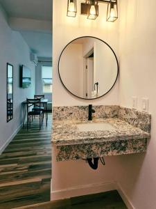 a bathroom with a sink and a mirror on the wall at Unit 3 Waena Inn Newly Renovated Maui Private Suite in Wailuku