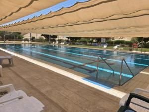 a large swimming pool with a large swimming pool at Zimmer Belev HaKikar- Dead sea in Neʼot HaKikar