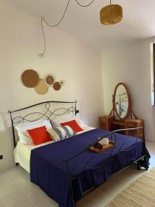 a bedroom with a bed with blue sheets and red pillows at Appartamento in casale Umbro vicino Orvieto - Allerona in Allerona +26 photos