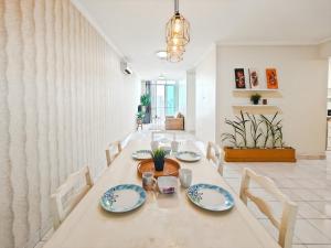 a dining room with a long table and chairs at Large 2BR Ambassador 2 Apt Pool, Gym, WiFi in Jakarta